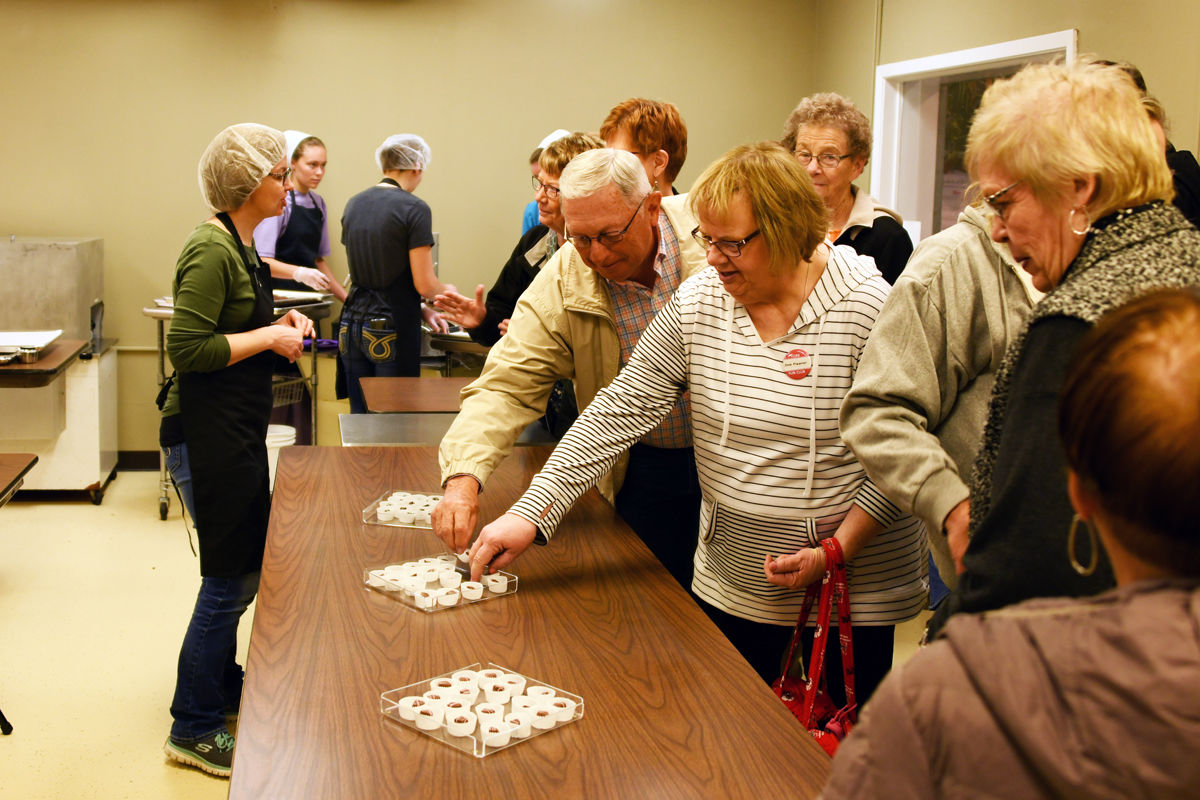 066 Don Regier and Deb Figgner reach for the samples.JPG